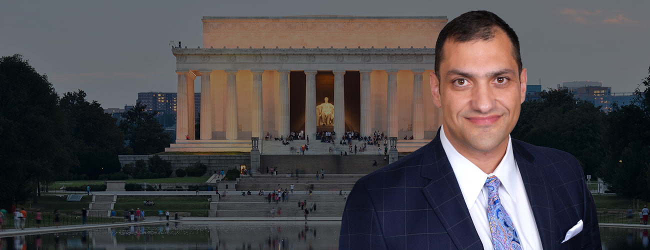 Attorney's photo with a contracy behind